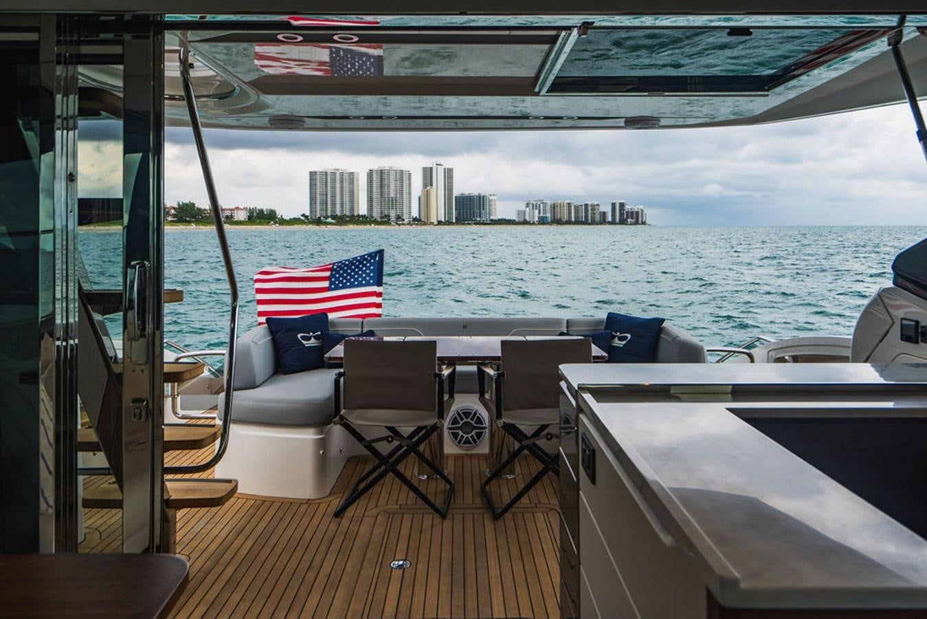 a deck with a view of a city and water aboard IMAGINE Yacht for Sale