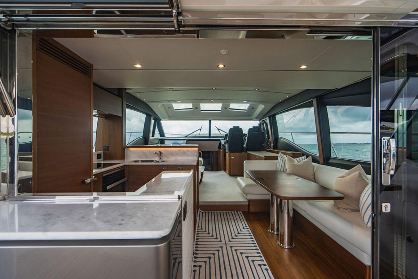 a room with a couch and a table aboard IMAGINE Yacht for Sale