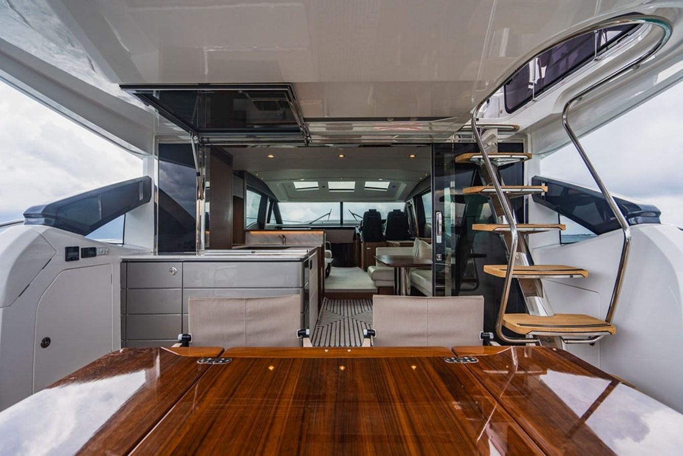 a room with a wood floor and a staircase aboard IMAGINE Yacht for Sale