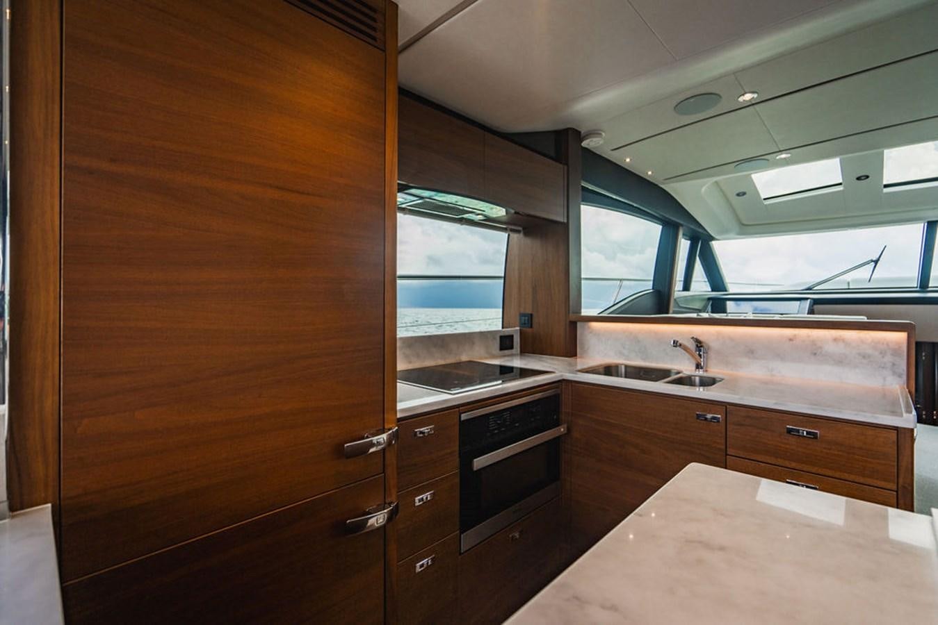a kitchen with wooden cabinets aboard IMAGINE Yacht for Sale