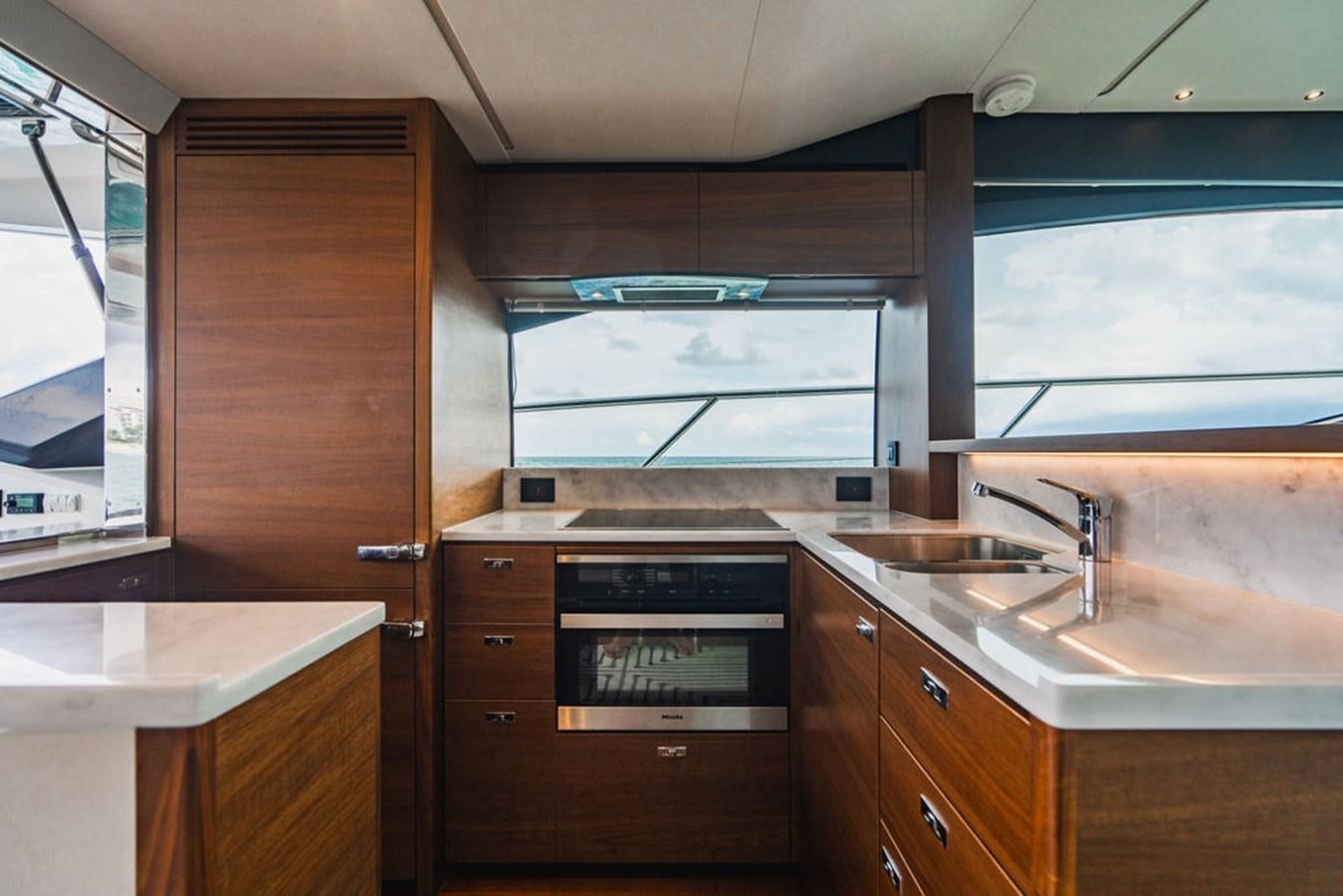 a kitchen with wooden cabinets aboard IMAGINE Yacht for Sale