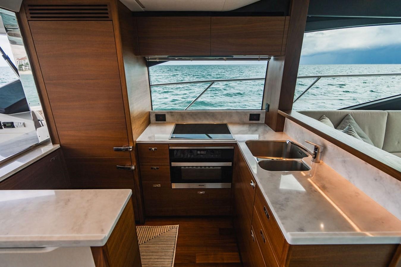 a kitchen with wooden cabinets aboard IMAGINE Yacht for Sale