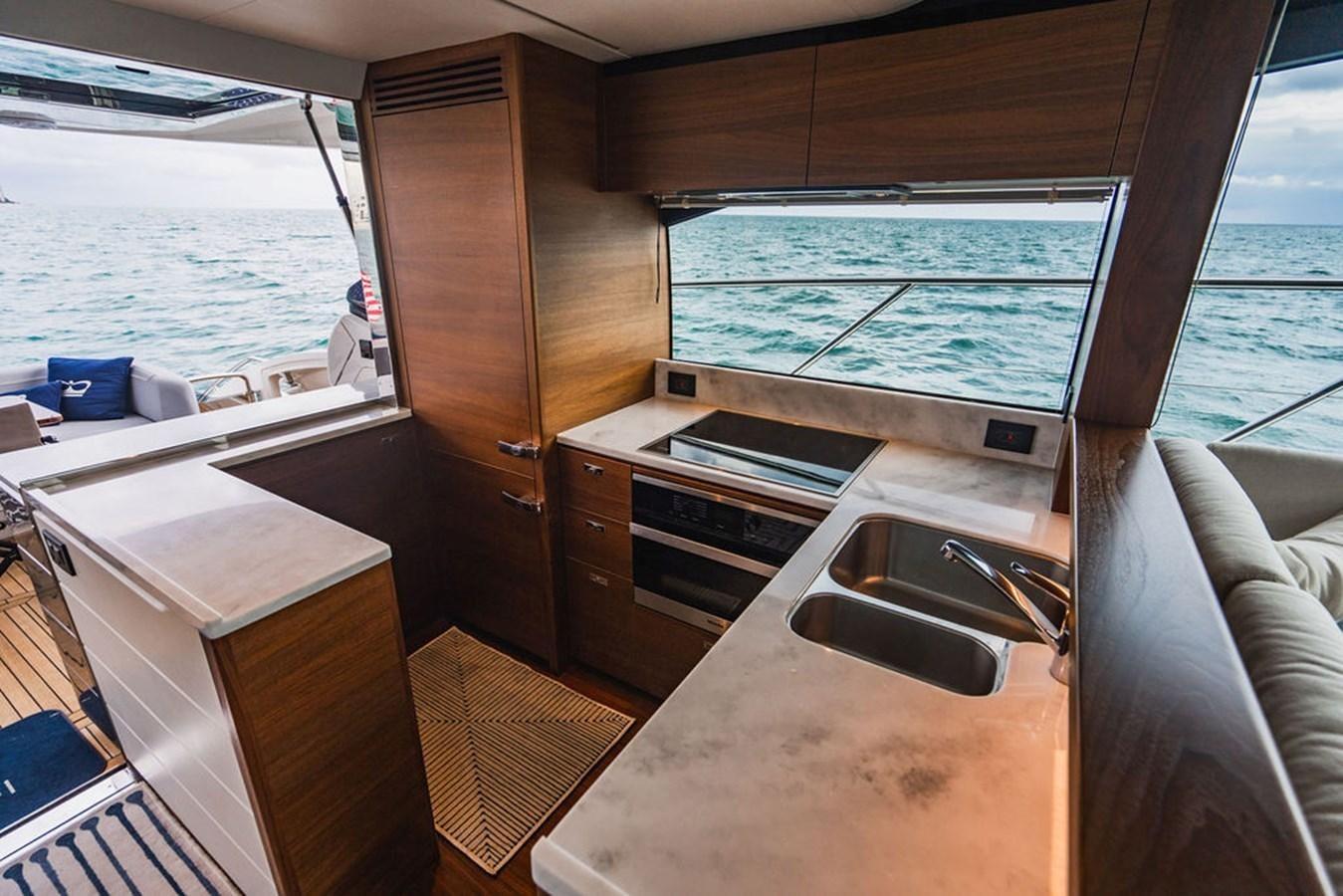 a kitchen with a sink and a large window aboard IMAGINE Yacht for Sale