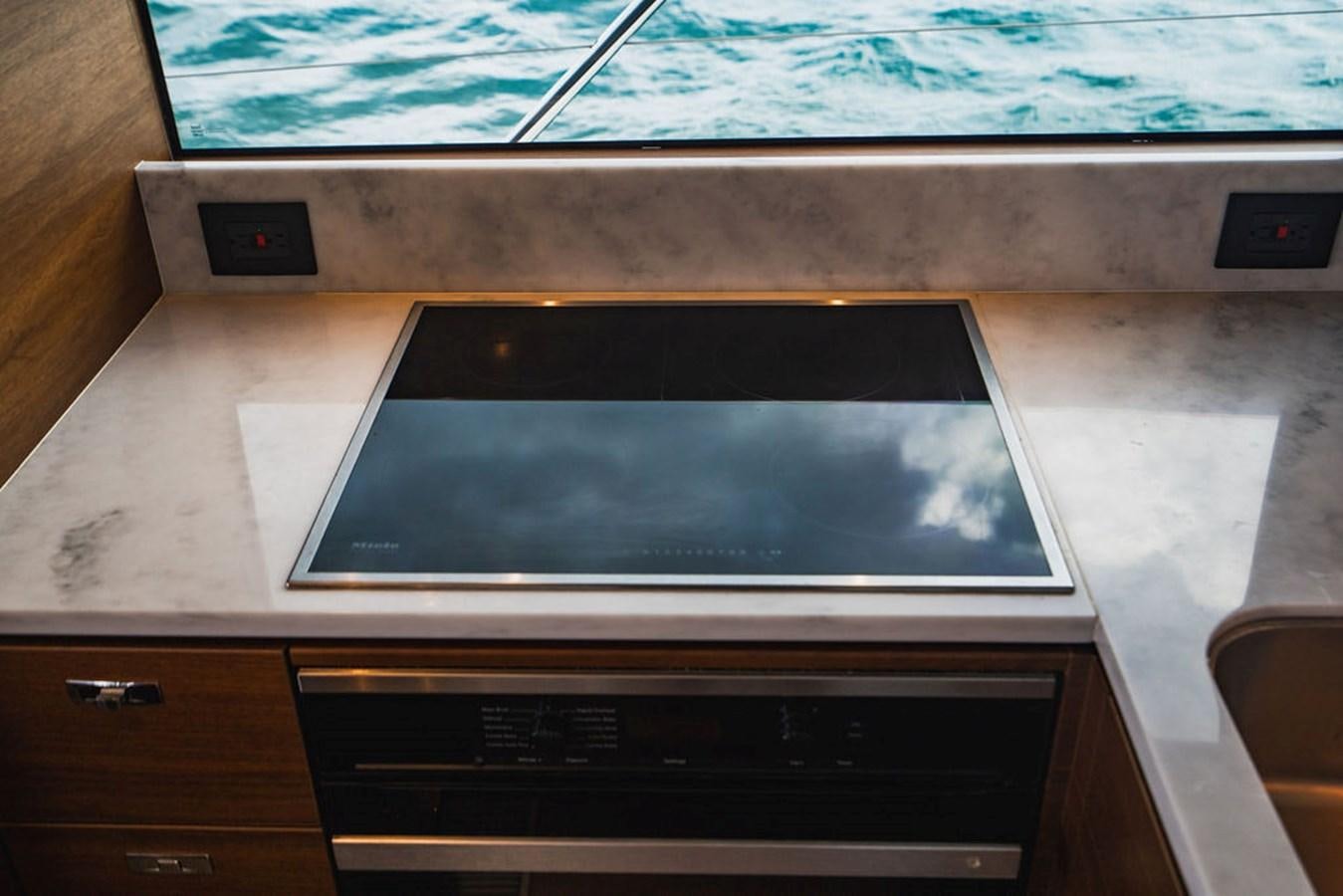 a tv on a table aboard IMAGINE Yacht for Sale