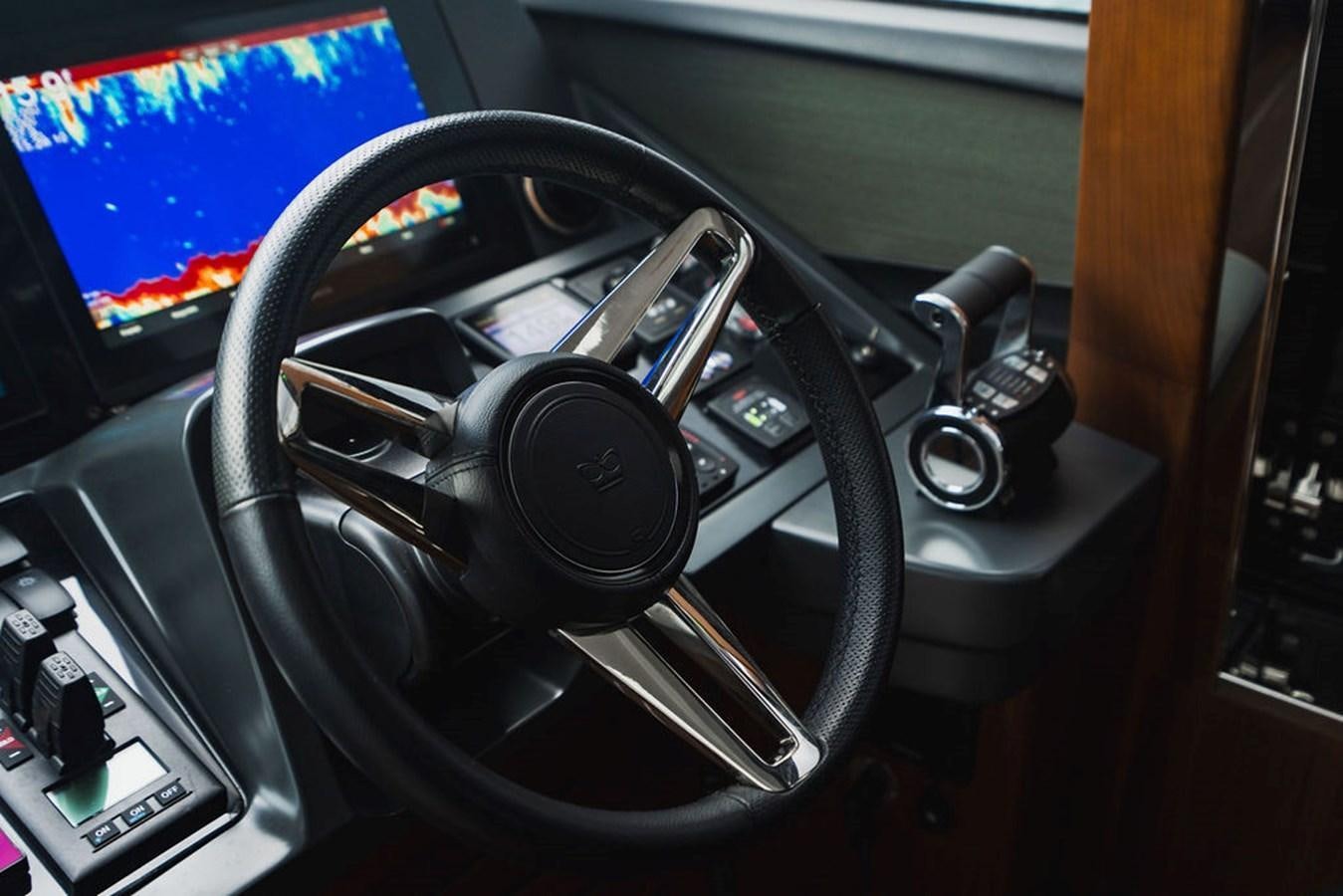 a black steering wheel aboard IMAGINE Yacht for Sale