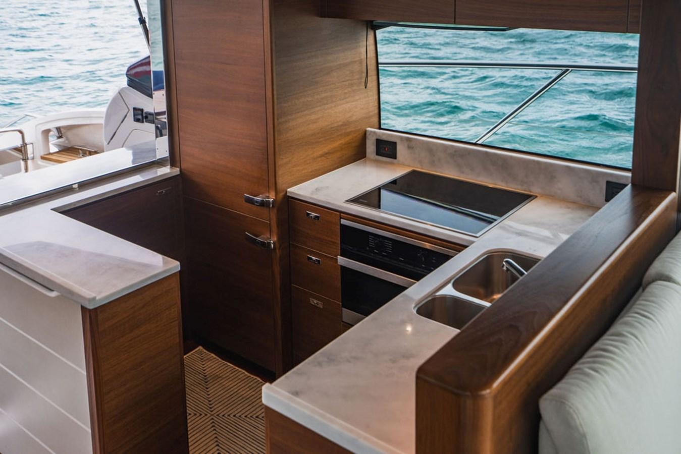a kitchen with a sink and a bathtub aboard IMAGINE Yacht for Sale