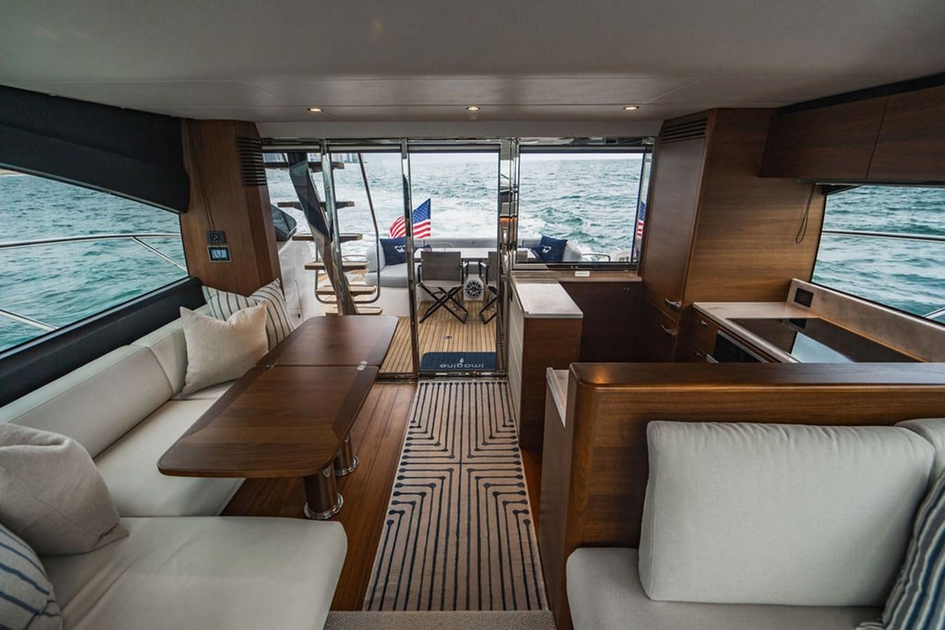 a boat with a table and chairs aboard IMAGINE Yacht for Sale
