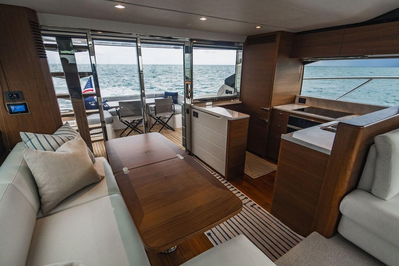 a living room with a large window aboard IMAGINE Yacht for Sale