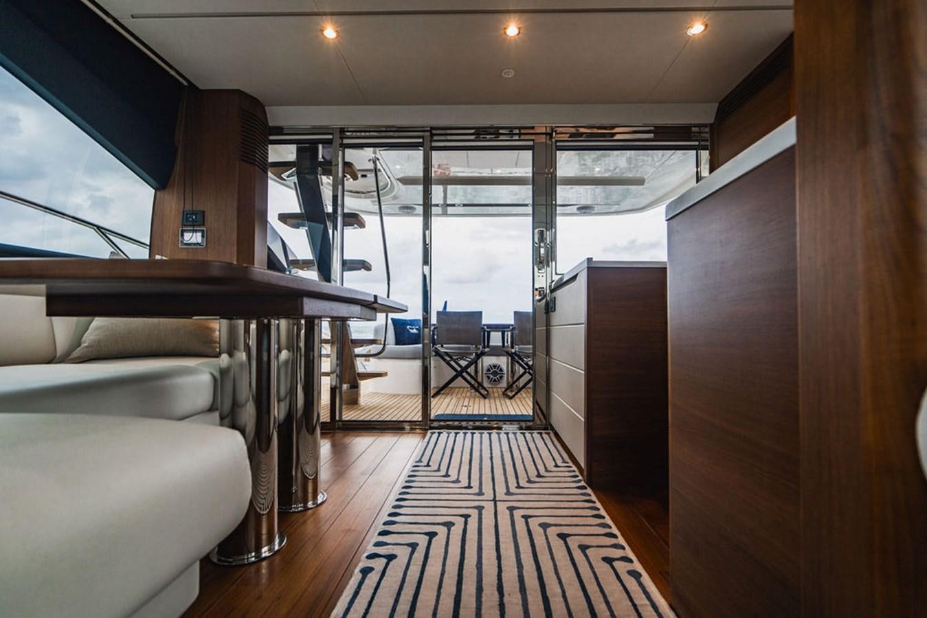 a room with a wood floor and a large window aboard IMAGINE Yacht for Sale