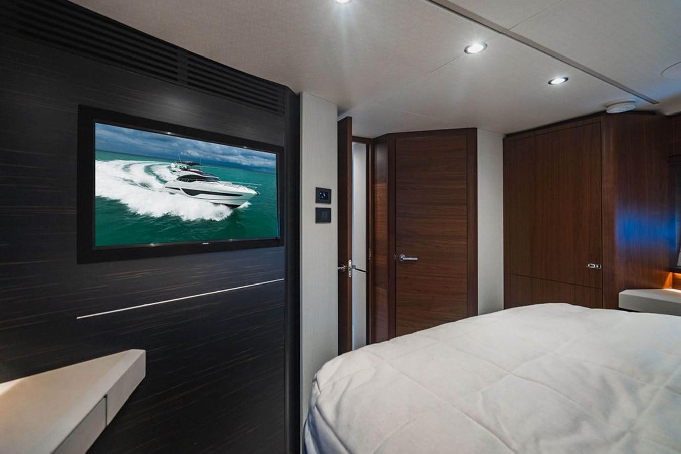 a room with a television and a bed aboard IMAGINE Yacht for Sale
