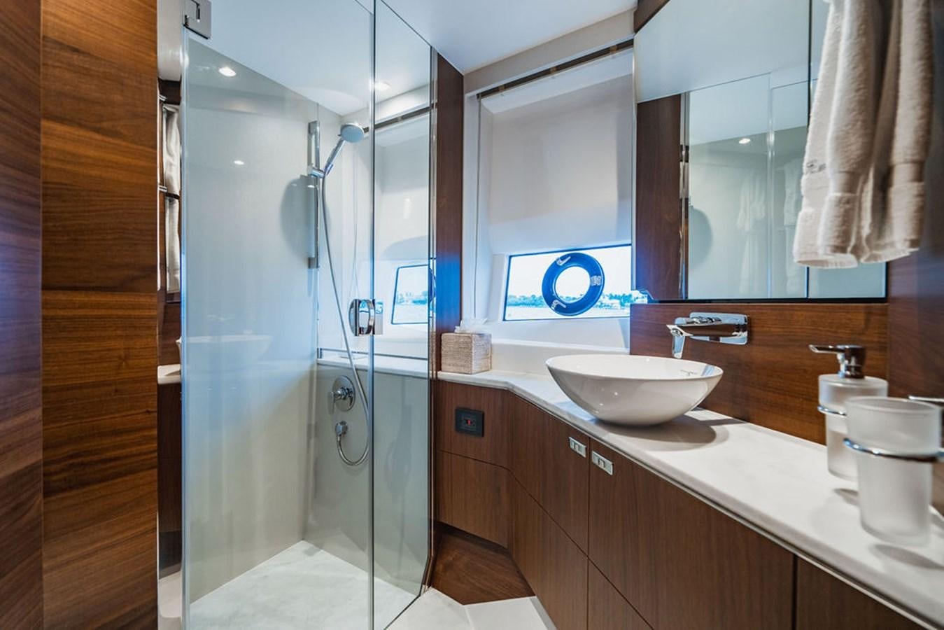 a bathroom with a glass shower aboard IMAGINE Yacht for Sale