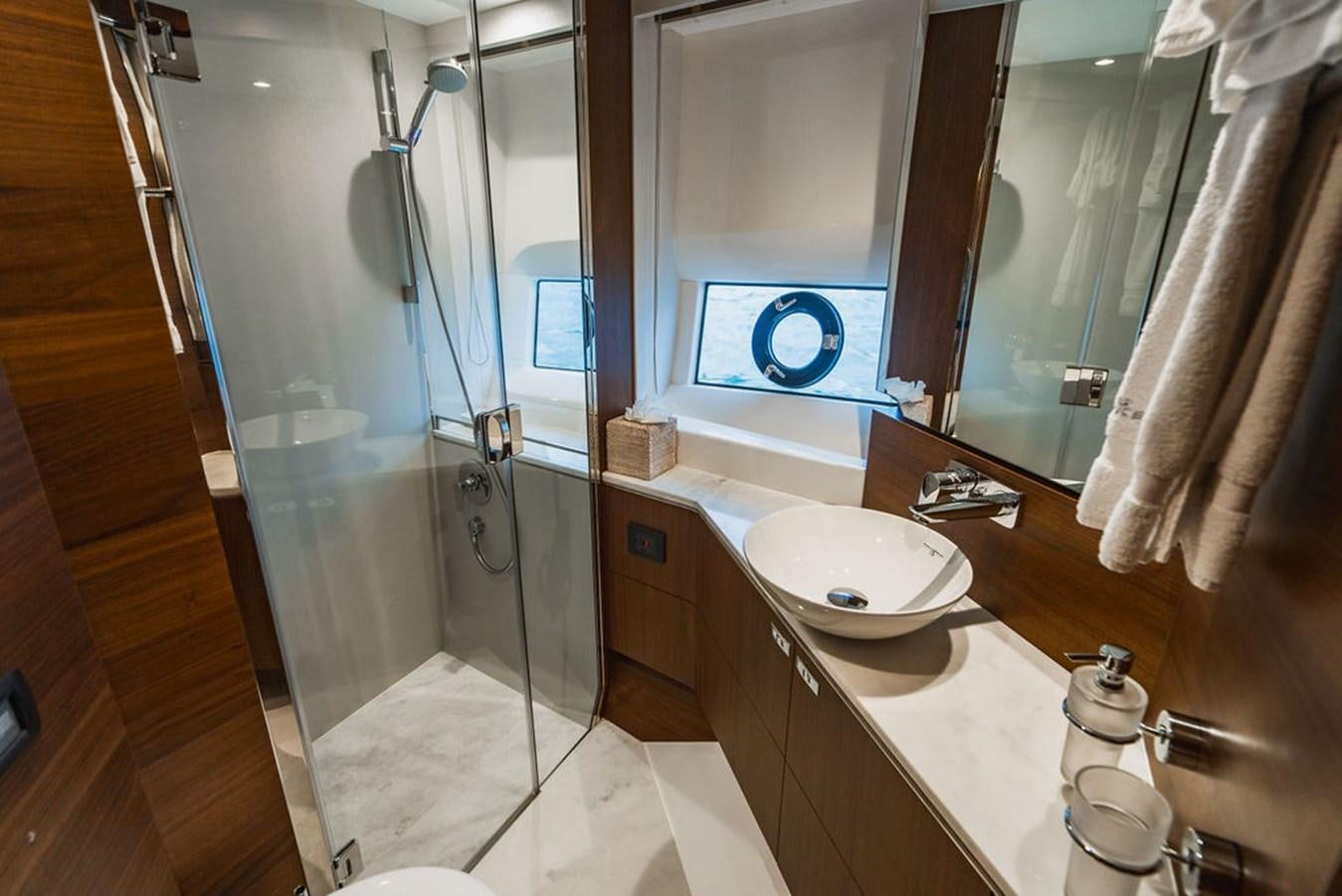 a bathroom with a glass shower aboard IMAGINE Yacht for Sale