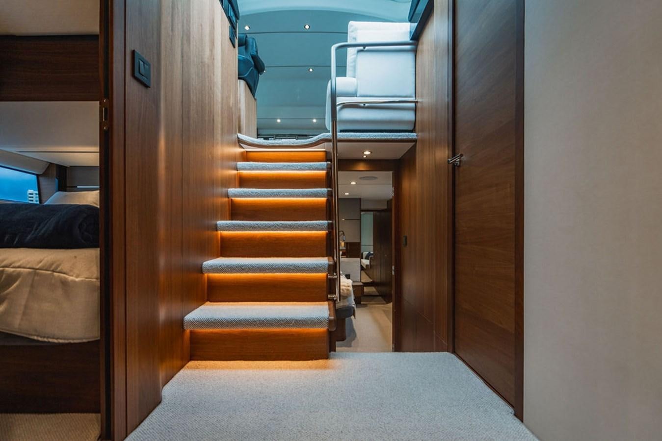 a hallway with a bed and a door aboard IMAGINE Yacht for Sale