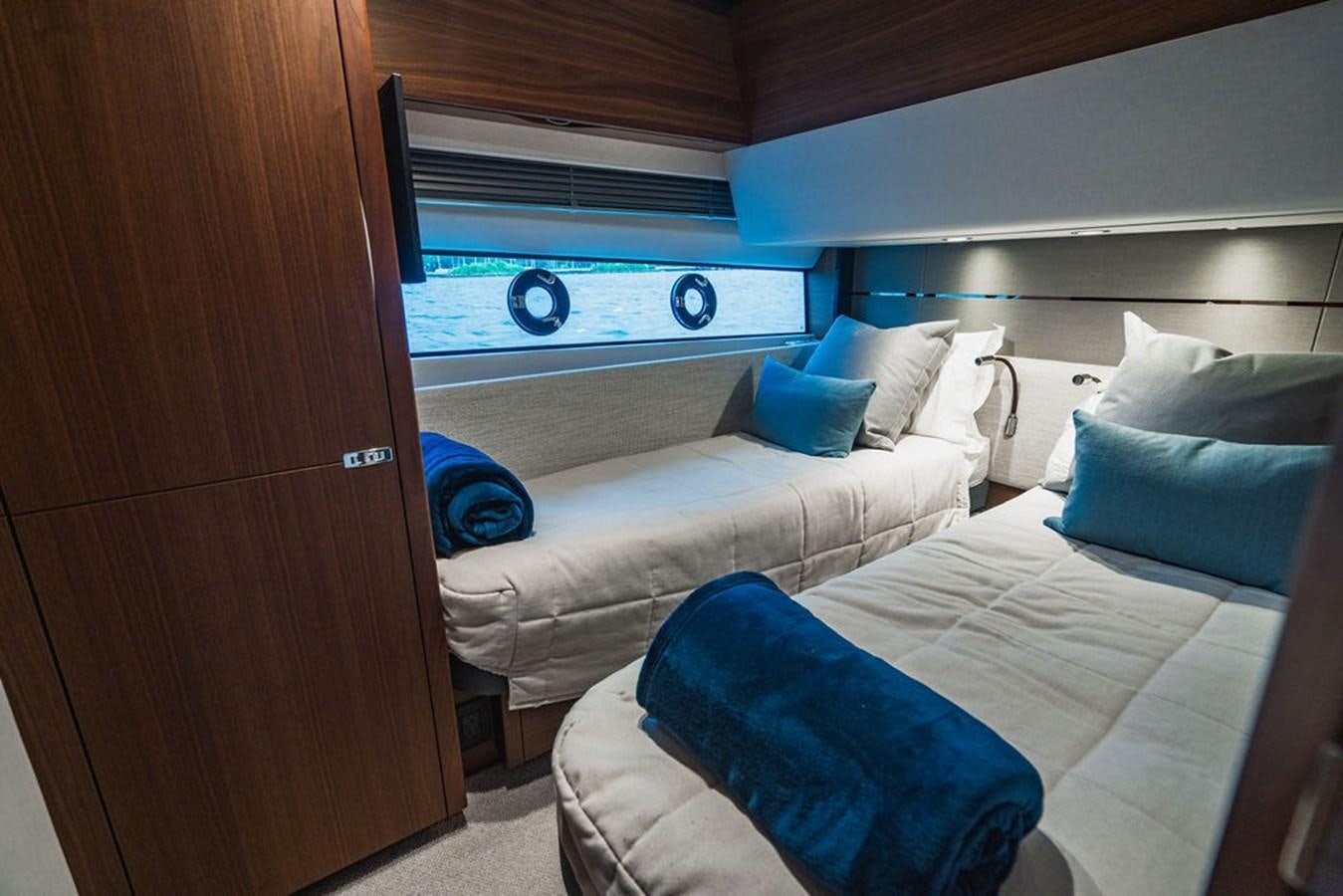 a room with a bed and a television aboard IMAGINE Yacht for Sale