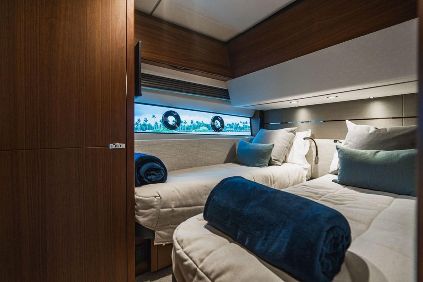 a room with a bed and a television aboard IMAGINE Yacht for Sale
