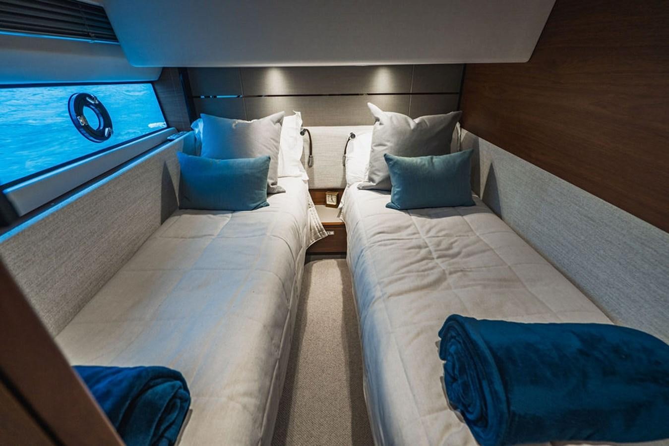 a room with a bed and a window aboard IMAGINE Yacht for Sale