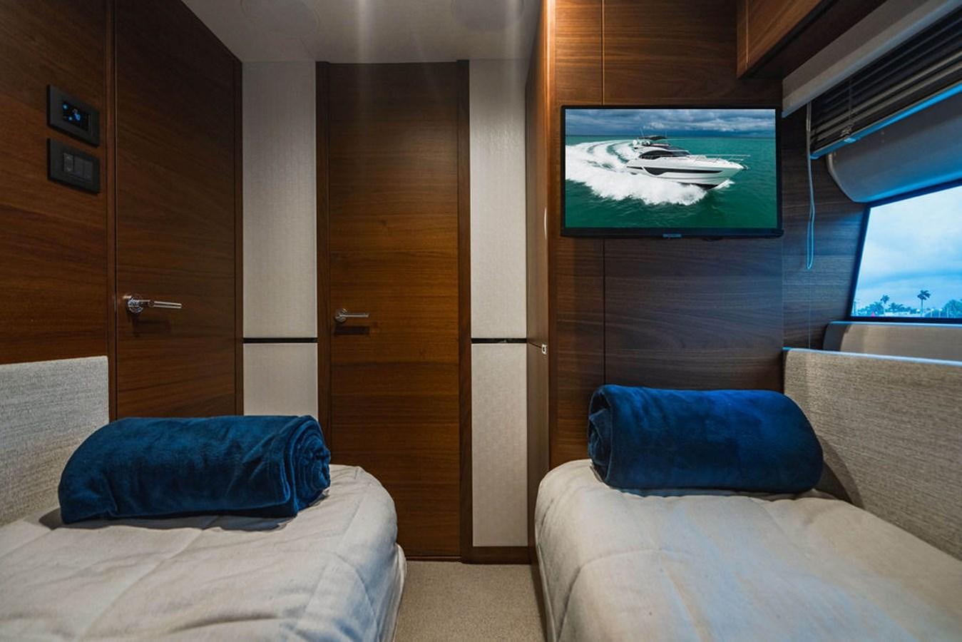 a room with a bed and a television aboard IMAGINE Yacht for Sale