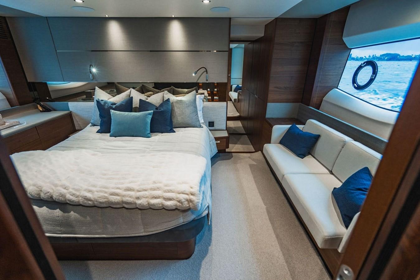 a room with a bed and a window aboard IMAGINE Yacht for Sale
