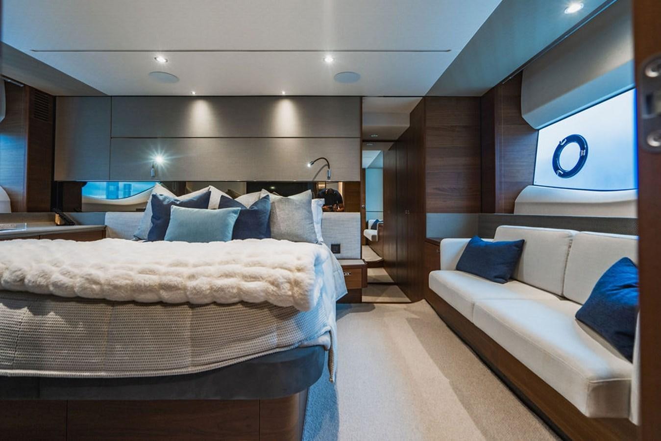 a room with a bed and a mirror aboard IMAGINE Yacht for Sale