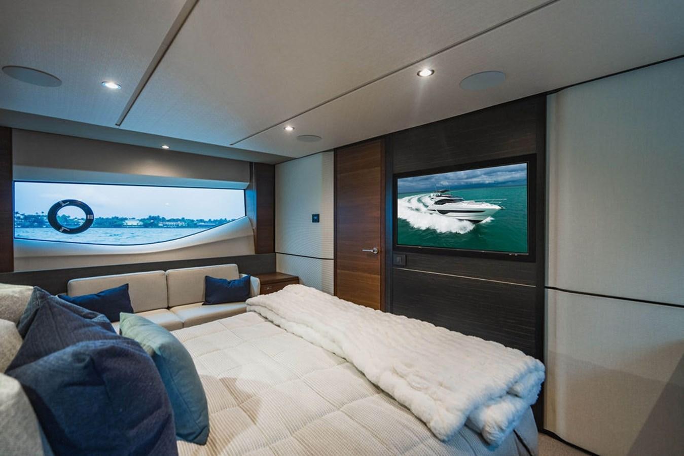 a bed with a large screen aboard IMAGINE Yacht for Sale
