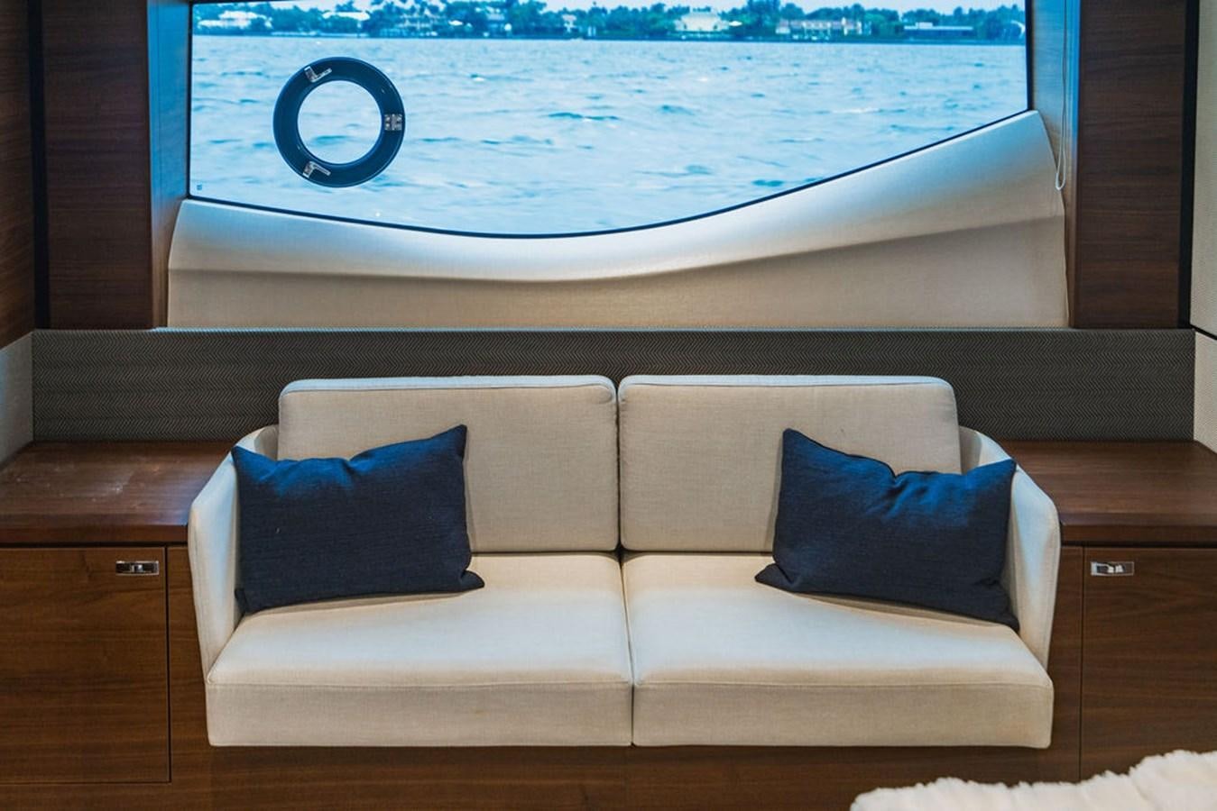 a couch with pillows on it aboard IMAGINE Yacht for Sale