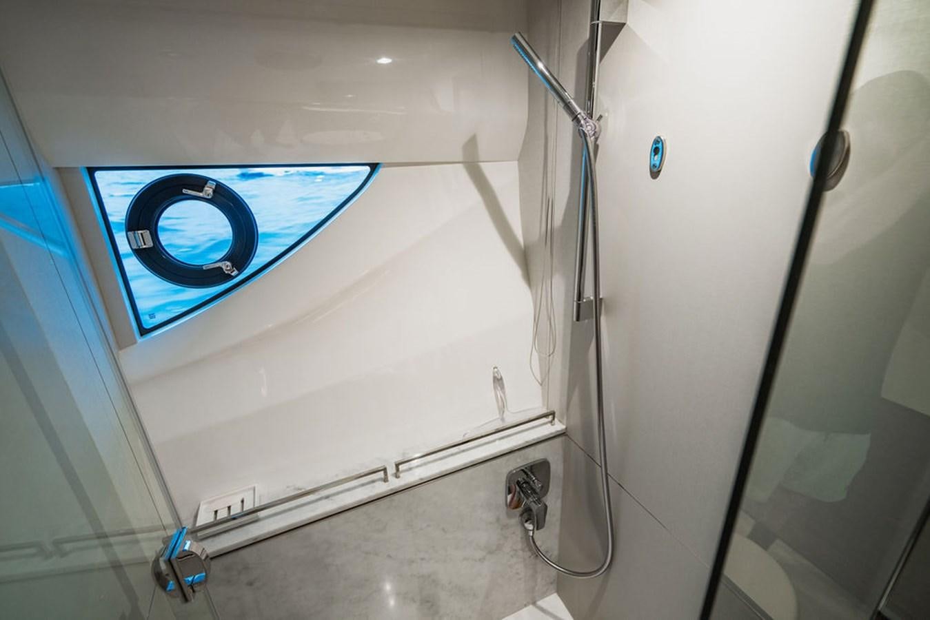 a white paneled wall with wires and a blue circle aboard IMAGINE Yacht for Sale