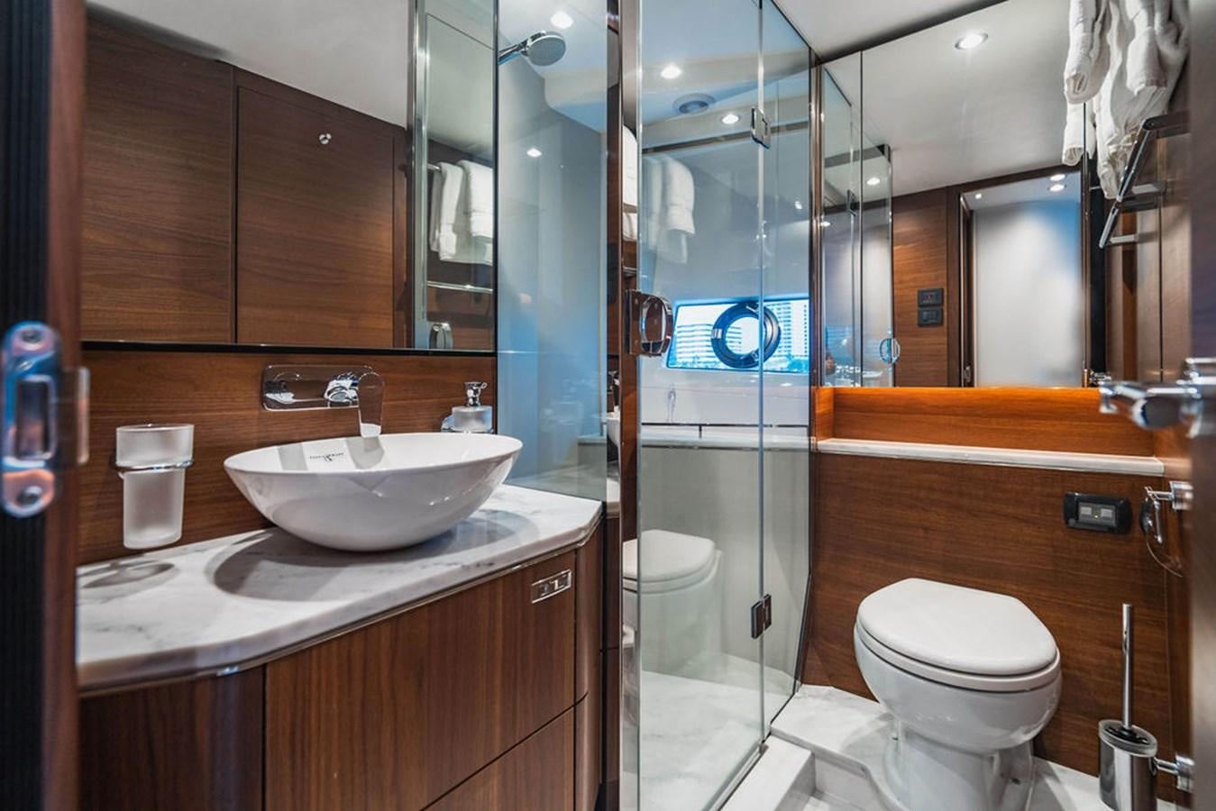 a bathroom with a glass shower aboard IMAGINE Yacht for Sale