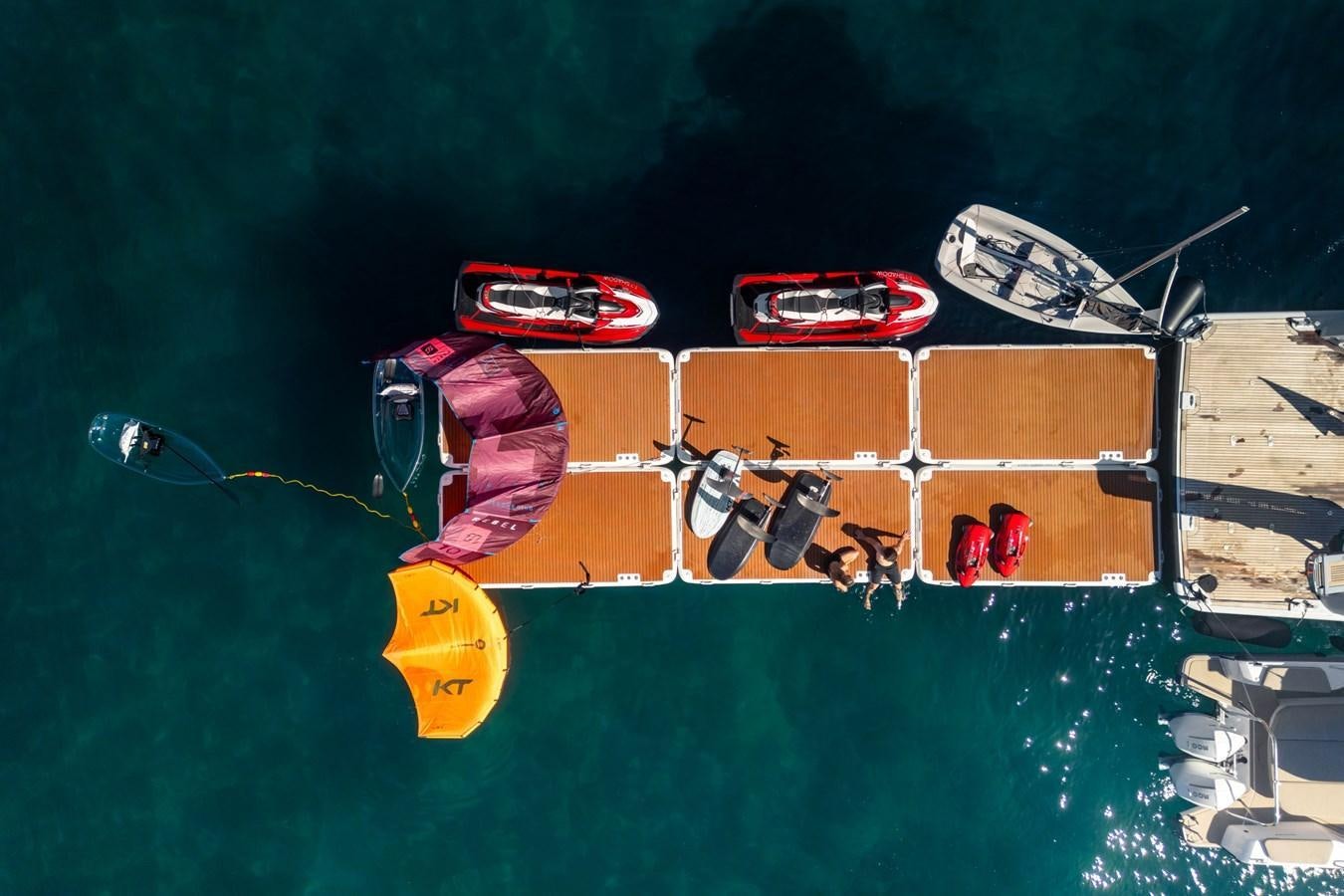 a group of people playing instruments on a green surface aboard SHADOW Yacht for Sale
