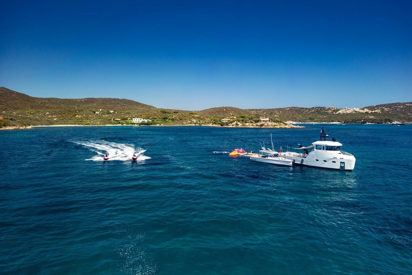 a couple of boats in the water aboard SHADOW Yacht for Sale