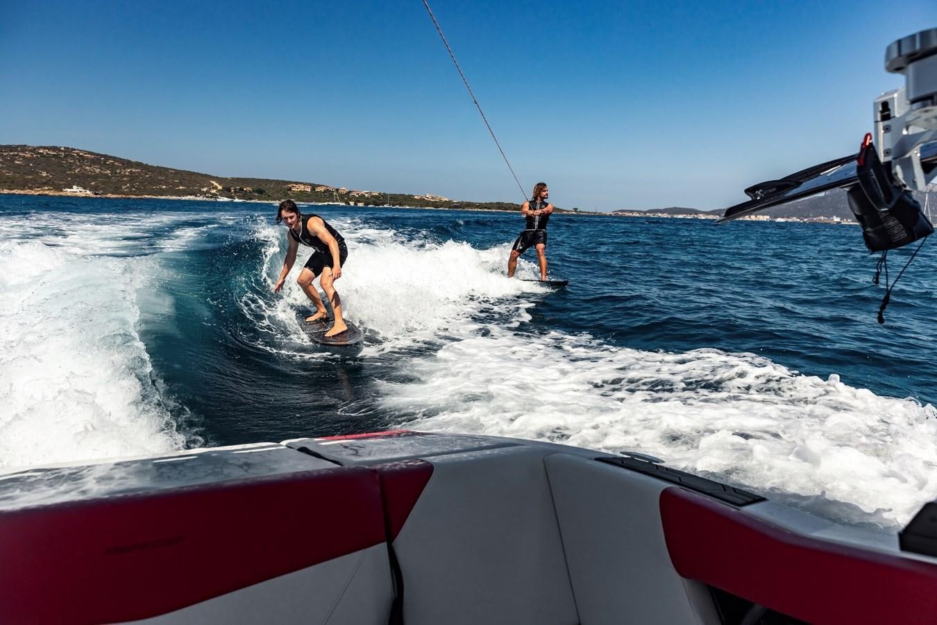 people are performing water skating aboard SHADOW Yacht for Sale