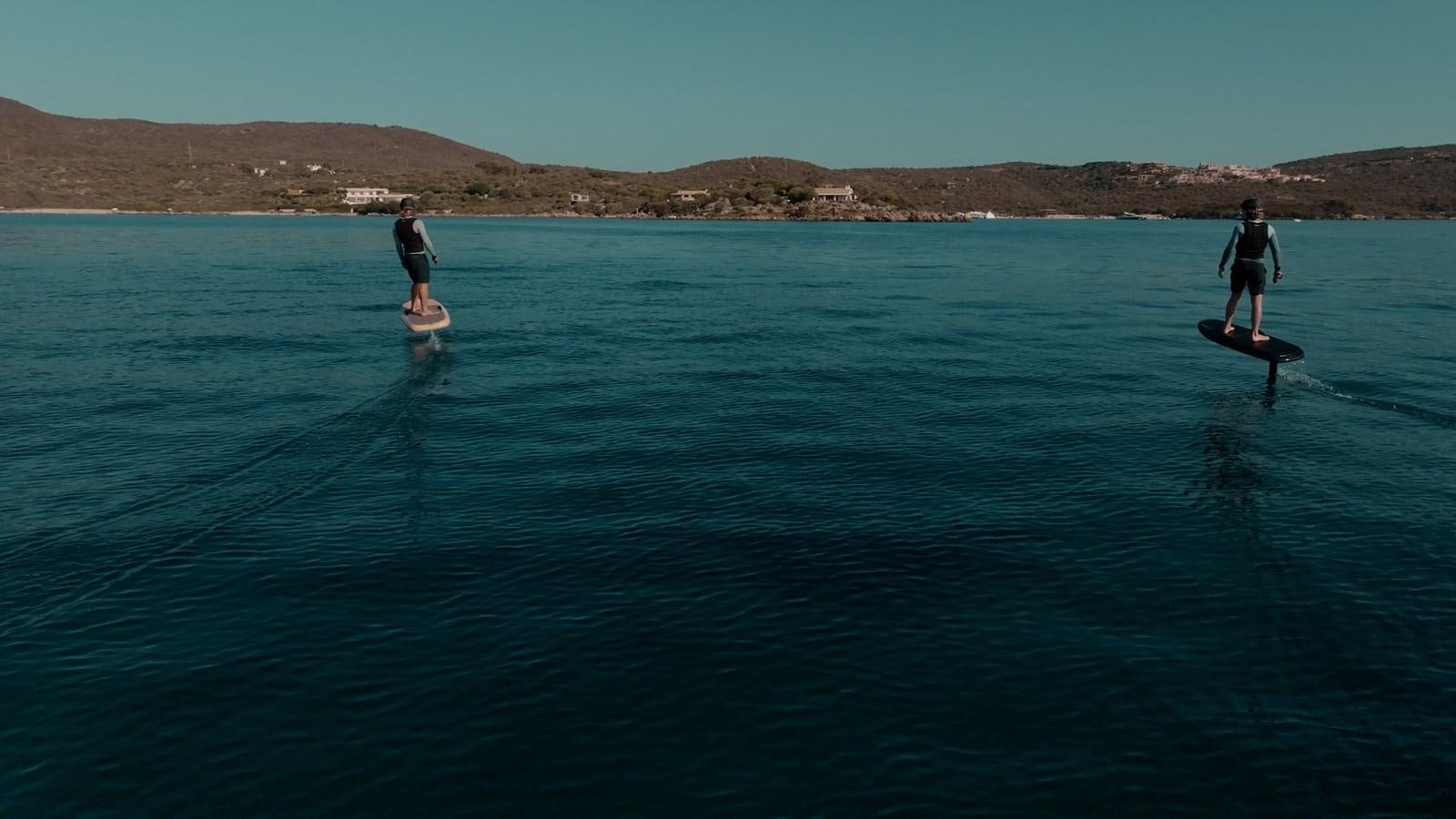 a couple of people on surfboards in the water aboard SHADOW Yacht for Sale