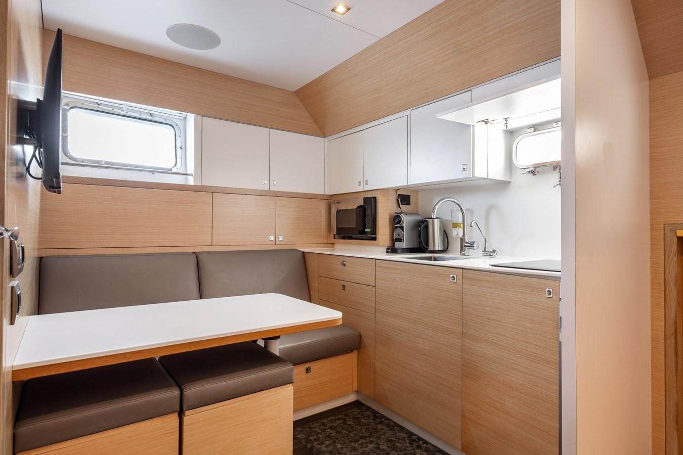 a kitchen with white cabinets aboard SHADOW Yacht for Sale