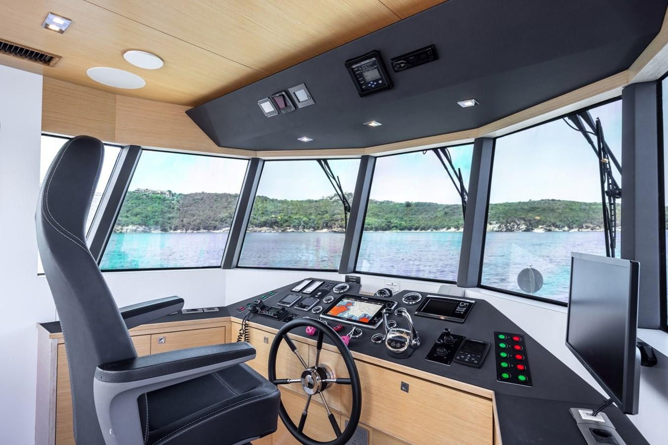 inside of a vehicle with a large window and a view of the mountains aboard SHADOW Yacht for Sale