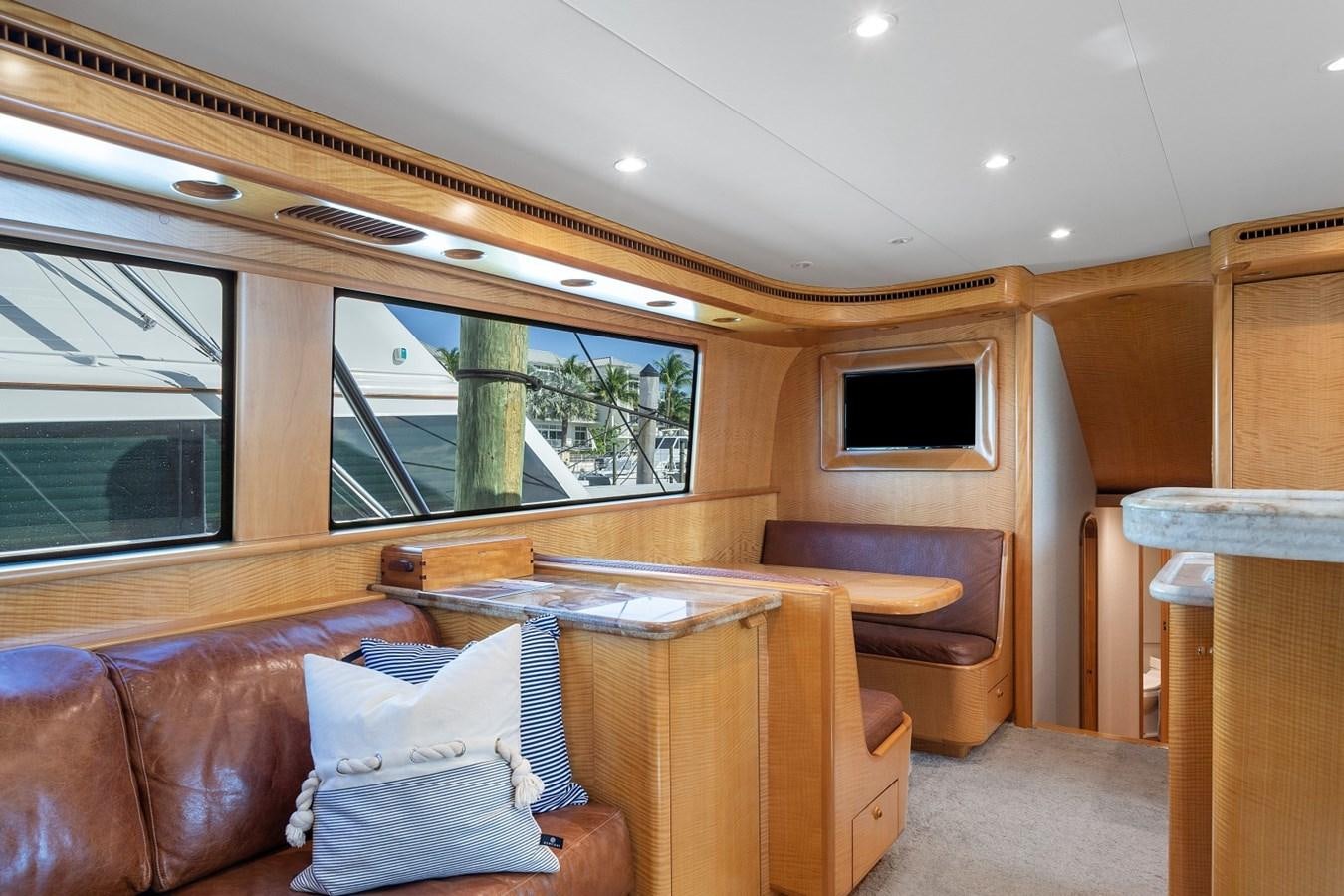a cabin with a couch and a television aboard WHISKEY KILO Yacht for Sale