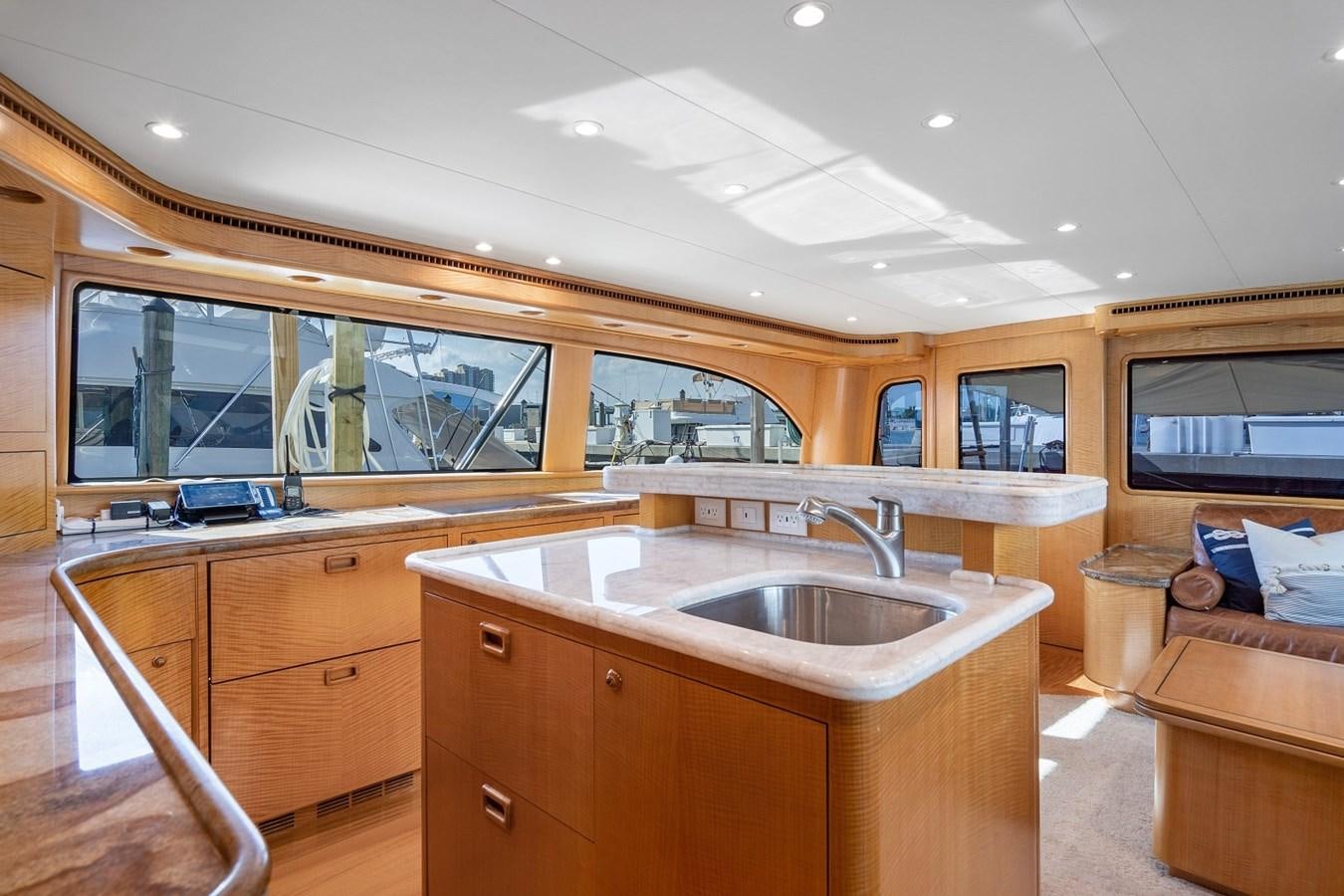a kitchen with wooden cabinets aboard WHISKEY KILO Yacht for Sale