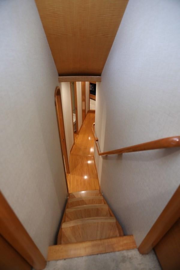 a staircase with a wood railing aboard WHISKEY KILO Yacht for Sale