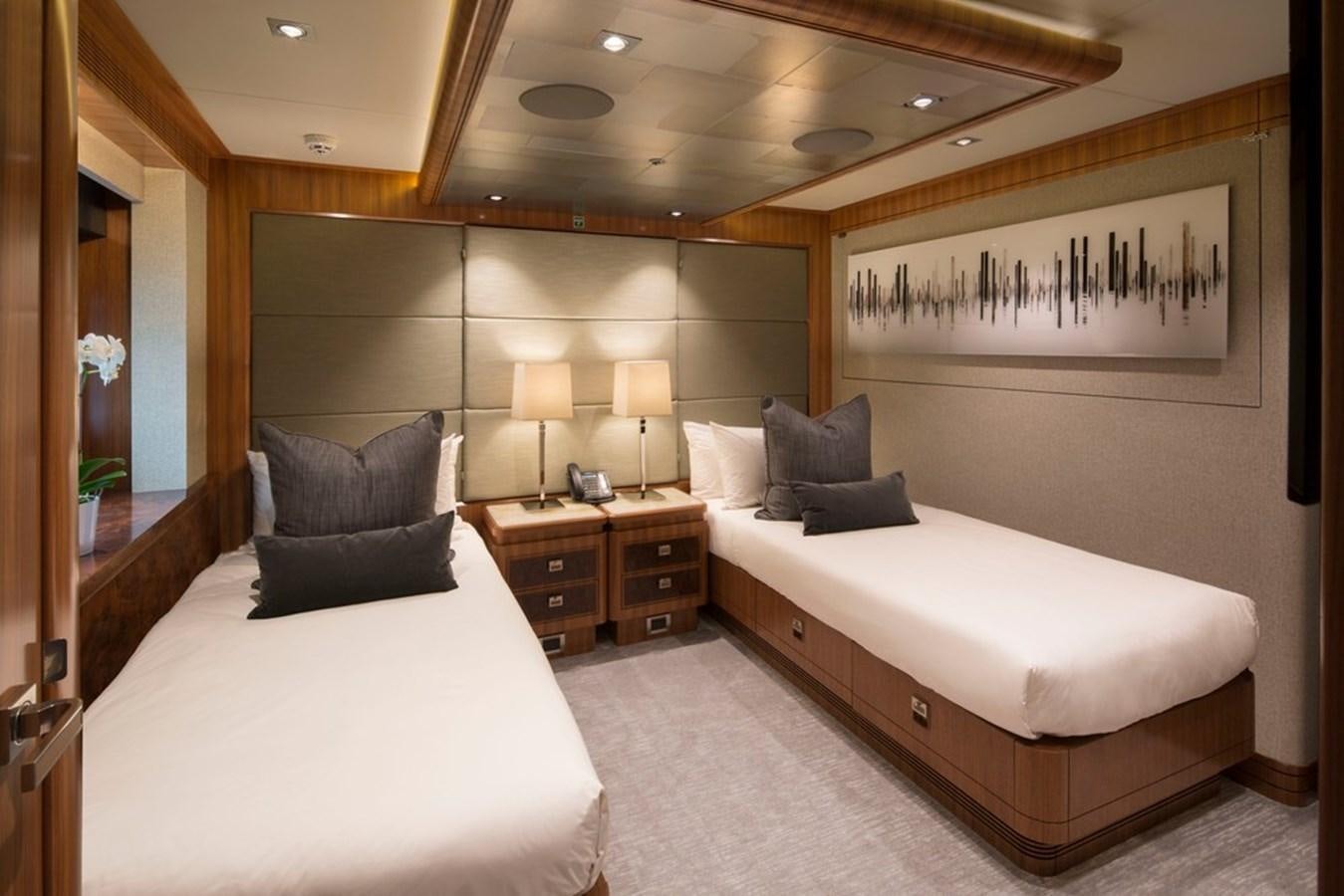 a hotel room with two beds aboard MUCHOS MAS Yacht for Sale