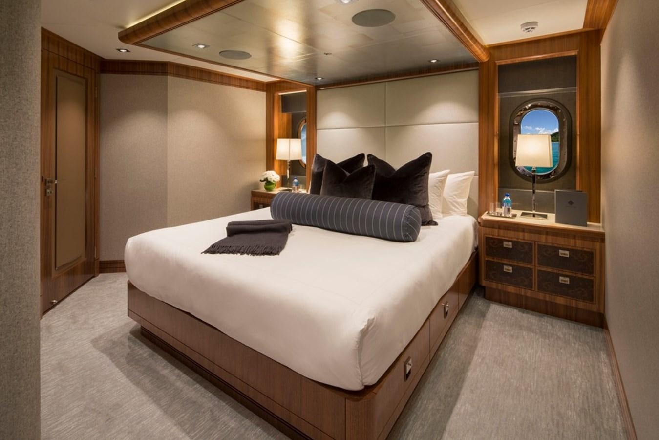 a hotel room with a large bed aboard MUCHOS MAS Yacht for Sale