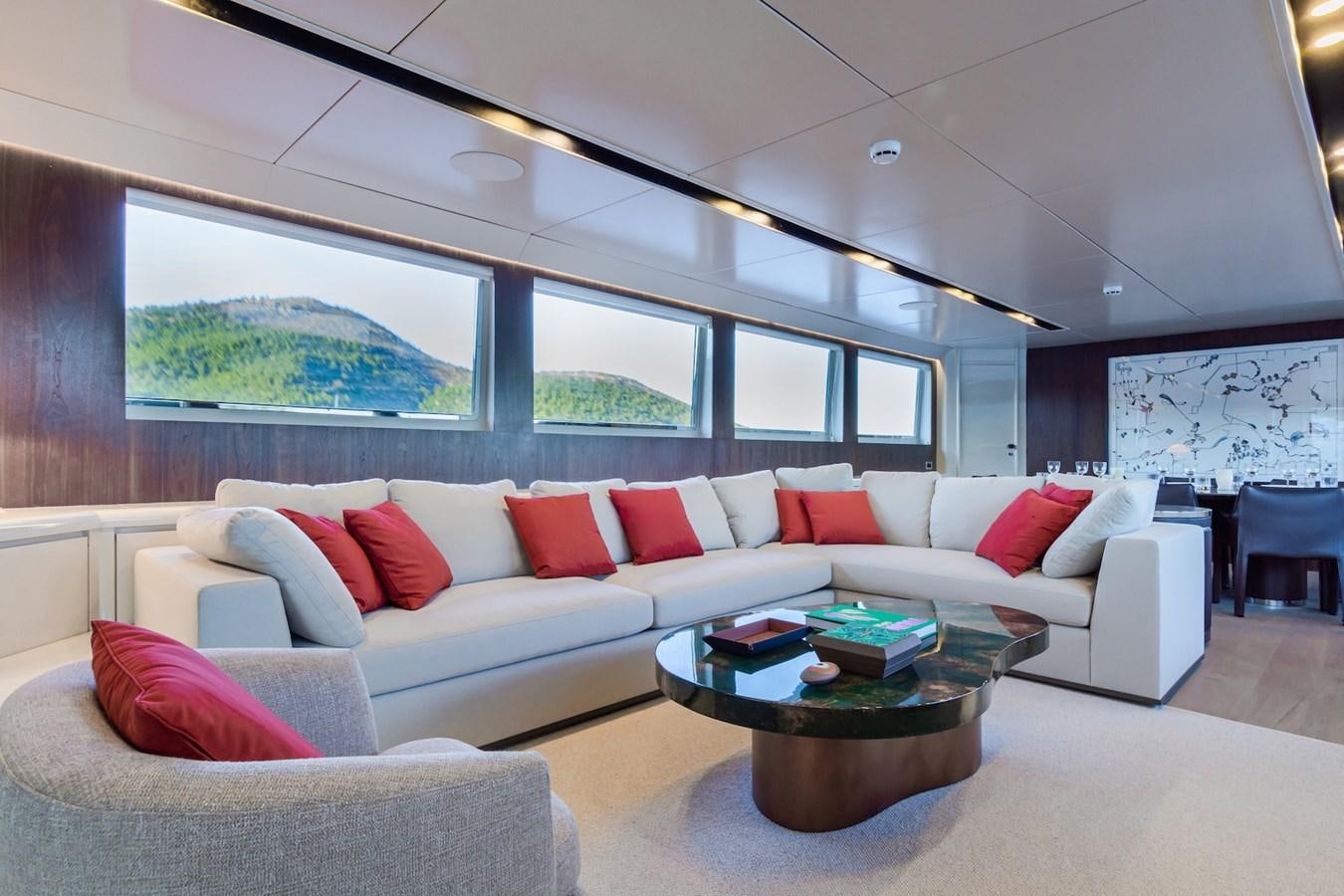 a living room with a couch and a table aboard AXELLA Yacht for Sale