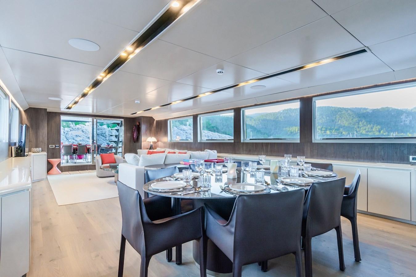a large dining room with a large table and chairs aboard AXELLA Yacht for Sale