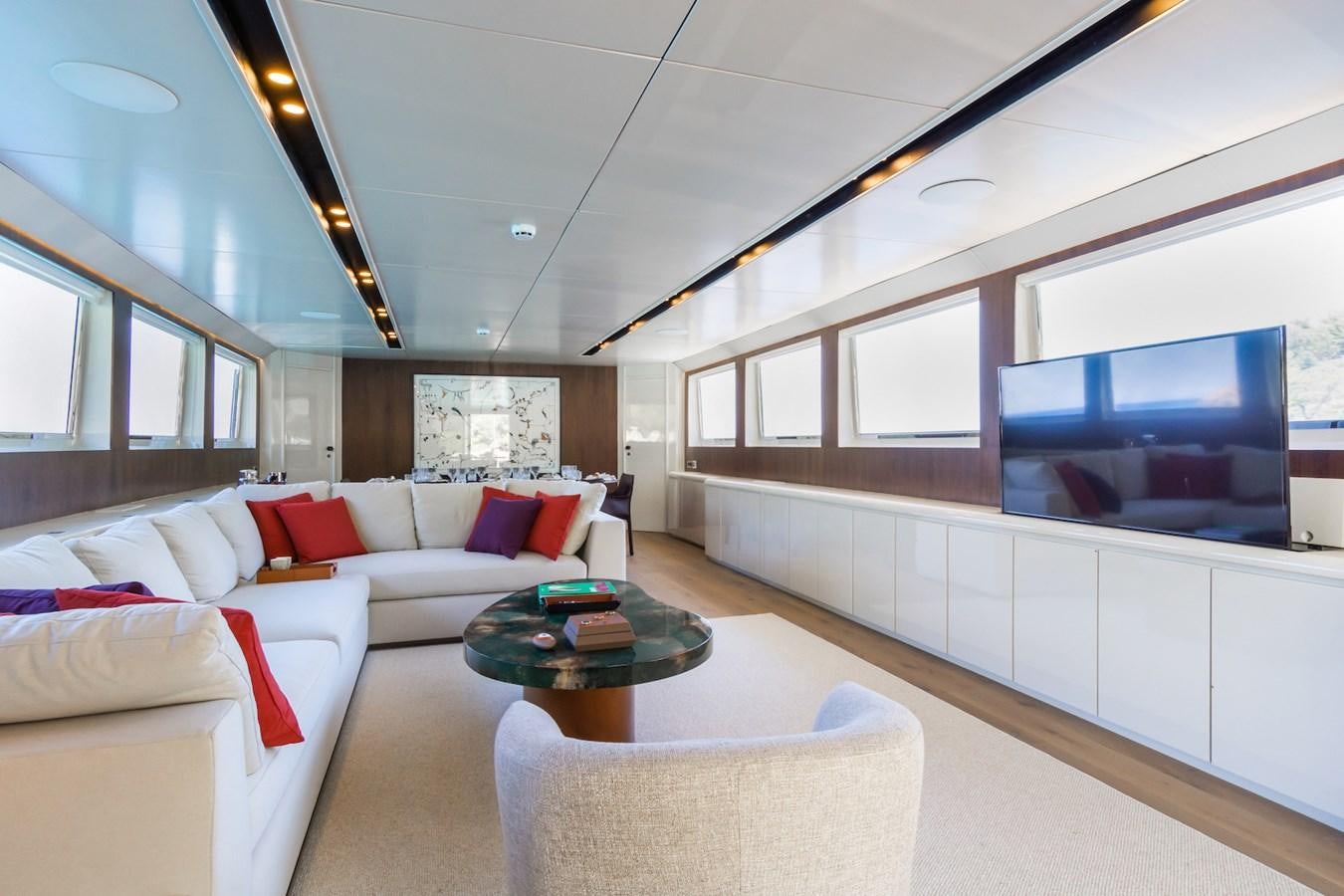 a living room with a couch and a television aboard AXELLA Yacht for Sale