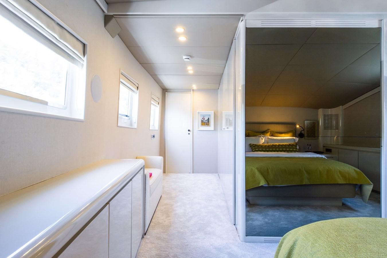 a room with a row of bunk beds aboard AXELLA Yacht for Sale