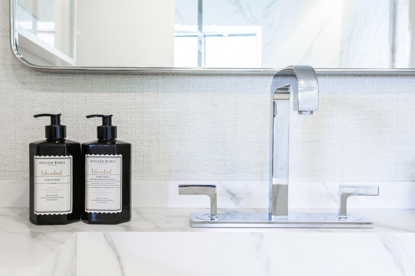a sink with a faucet and a soap dispenser aboard AXELLA Yacht for Sale