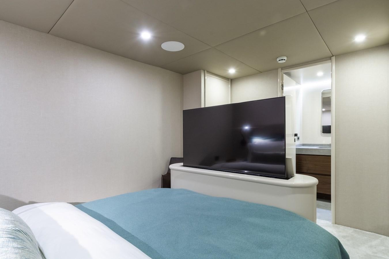 a bedroom with a tv on the wall aboard AXELLA Yacht for Sale