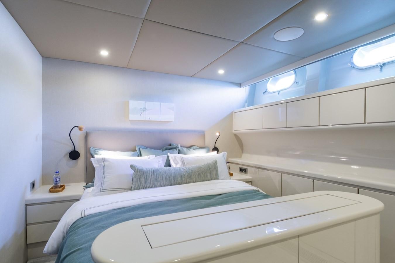 a room with a bed and a white wall aboard AXELLA Yacht for Sale