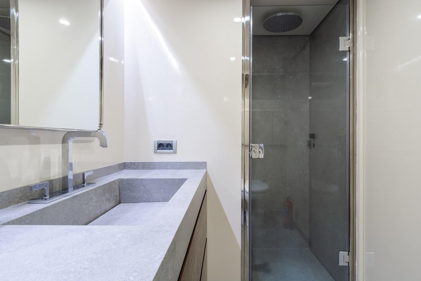 a bathroom with a sink and a shower aboard AXELLA Yacht for Sale