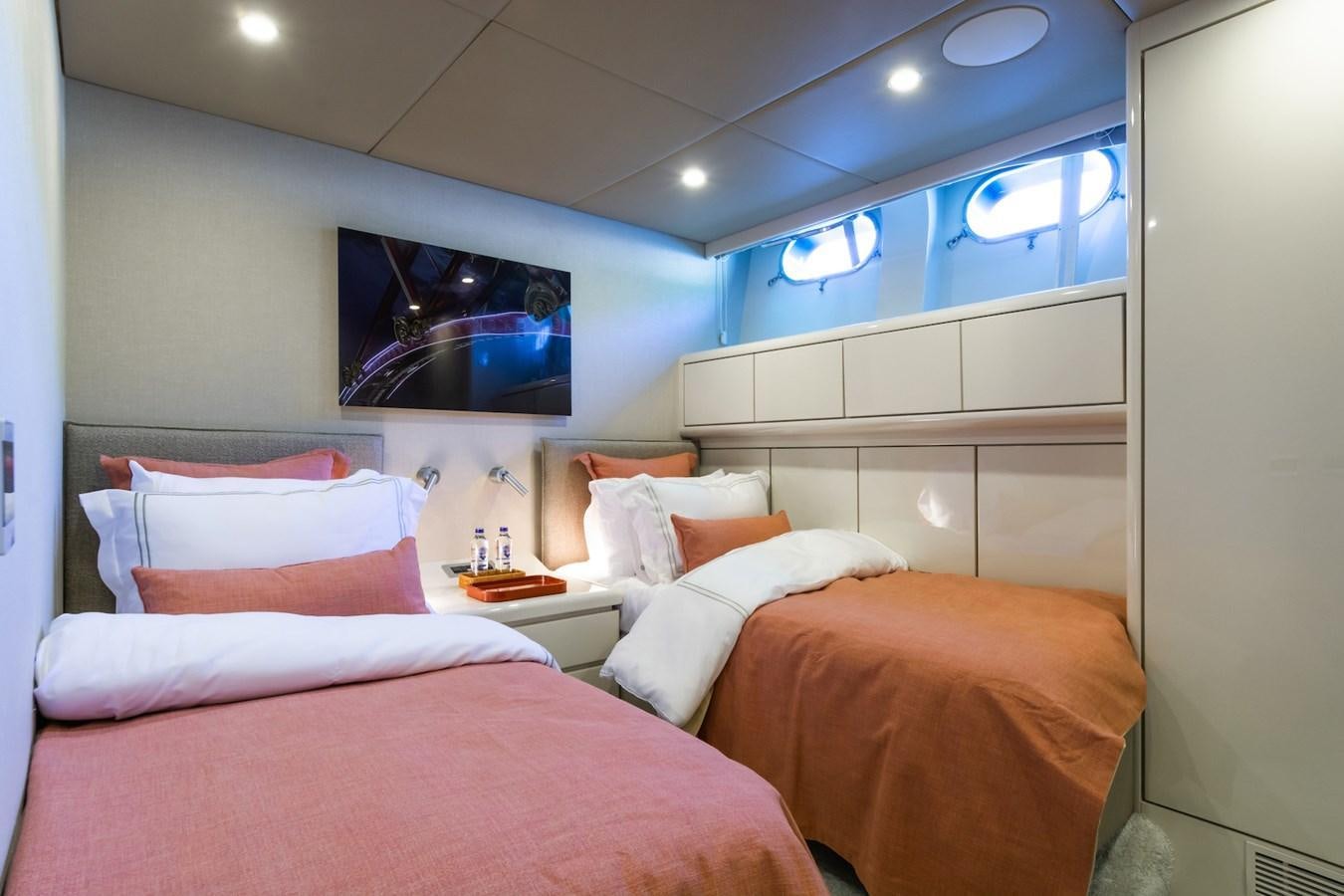 a room with three beds aboard AXELLA Yacht for Sale