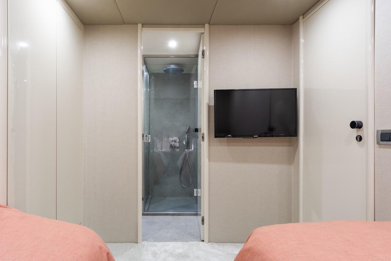 a room with a tv and a bed aboard AXELLA Yacht for Sale