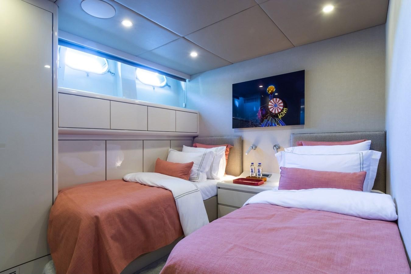 a room with three beds aboard AXELLA Yacht for Sale