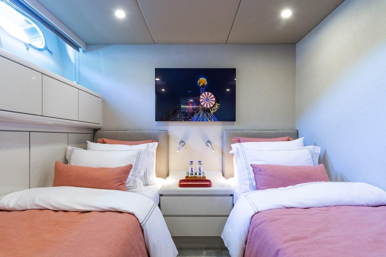 a room with a bed and a painting on the wall aboard AXELLA Yacht for Sale